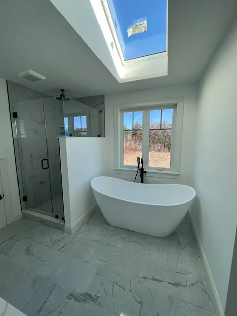 Bathroom Remodel by YK United Builders — Marble tile and skylight