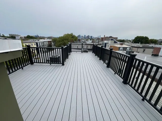 Rooftop Deck by YK United Builders — Composite decking above the city