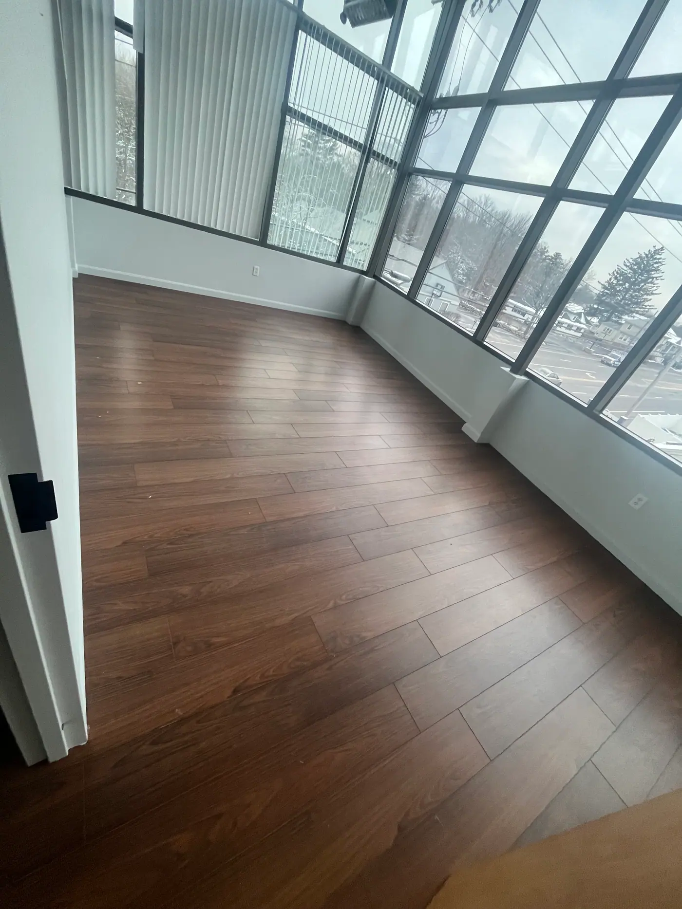 Corner Suite Flooring — Warm plank flooring in a glazed corner room